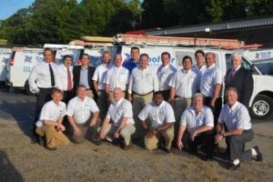 team of HVAC technicians in front of a Cool Air Mechanical van